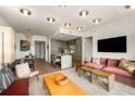 Inviting living room flowing to kitchen, featuring modern furnishings, sleek decor, and hardwood floors at 2233 Peachtree Ne Rd # 1207, Atlanta, GA 30309