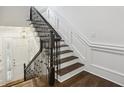 Elegant staircase with dark wood steps, white risers, and decorative black iron railing at 3707 Peachtree Ne Rd # 8, Atlanta, GA 30319