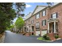 Charming brick townhomes feature front-entry garages, landscaped yards, and classic architectural details at 3707 Peachtree Ne Rd # 8, Atlanta, GA 30319