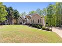 Landscaped front yard leads up to a cozy home exterior with stone accents and inviting curb appeal at 840 Whitby Dr, Douglasville, GA 30134