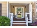 Inviting covered front porch featuring stone accents and a decorative glass door at 840 Whitby Dr, Douglasville, GA 30134