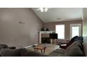 Cozy living room featuring hardwood floors, high ceiling, and a fireplace at 4175 Round Stone Dr, Snellville, GA 30039