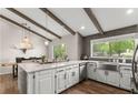 Bright kitchen with vaulted ceilings, wood beams, large island, and stainless steel appliances at 230 Summerfield Dr, Alpharetta, GA 30022