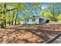 This charming home features a convenient carport and lovely landscaping at 3795 Willowbrook Dr, Douglasville, GA 30135
