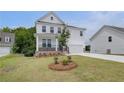 Attractive two-story home with a covered porch and a landscaped front yard at 540 Teversham Dr, Mcdonough, GA 30253