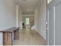 Bright foyer with beautiful hardwood floors, an entry table, and a view into the living room at 540 Teversham Dr, Mcdonough, GA 30253