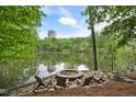 Beautiful lake view with fire pit and Adirondack chairs at 960 Tiverton Ln, Alpharetta, GA 30022