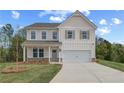 Charming two-story home with a well-manicured lawn, a two-car garage, and a classic architectural design at 576 Teversham Dr, Mcdonough, GA 30253