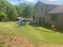 Expansive backyard featuring playset and trampoline, perfect for outdoor activities and Gathering fun at 1500 Country Ct, Auburn, GA 30011