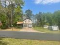 Charming two-story home with a two-car garage and extra storage building at 1500 Country Ct, Auburn, GA 30011