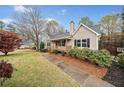 Well-maintained front yard featuring a sidewalk, a mature tree, and lush shrubbery adding to the home's appeal at 162 Brookhaven Way, Rockmart, GA 30153