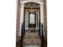Inviting front entrance with a black door, brick facade, and decorative iron railings at 2548 Gadsen Walk, Duluth, GA 30097