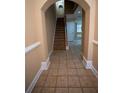 Spacious hallway with neutral tile flooring, leading to an open floor plan and staircase at 2548 Gadsen Walk, Duluth, GA 30097