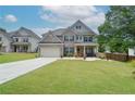 Beautiful two-story home featuring brick accents, a well-manicured lawn, and a two-car garage at 2589 Cajun Dr, Marietta, GA 30066