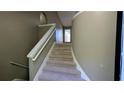 Carpeted stairway featuring a unique curved wall at 510 Ward Rd, Ellenwood, GA 30294