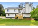 Two-story home with a new deck, white siding, black trim and a well-maintained lawn at 3152 Normandy Ne Cir, Marietta, GA 30062