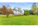 Bright two-story home with an open lawn, wooden front steps, and mature trees at 3152 Normandy Ne Cir, Marietta, GA 30062