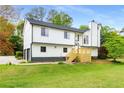 Charming two-story home featuring a two car garage, new wooden steps and a green lawn at 3152 Normandy Ne Cir, Marietta, GA 30062