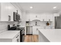 Bright modern kitchen featuring white cabinets, stainless steel appliances, and stylish backsplash at 3152 Normandy Ne Cir, Marietta, GA 30062