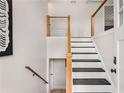 Modern staircase with wooden railings, black treads, and white risers at 3152 Normandy Ne Cir, Marietta, GA 30062