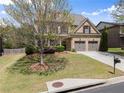 Well-maintained two-story brick home with an attached two-car garage and landscaped front yard at 550 Eldridge Dr, Suwanee, GA 30024