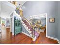 Elegant foyer with hardwood floors, staircase with iron railings, and view into the living room at 3465 Summit Trl, Cumming, GA 30041