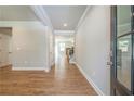 Inviting foyer with wood floors and an open view into the living spaces and staircase at 3981 Adler Cir, Buford, GA 30519