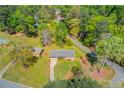 Overhead view of the property with lush landscaping, a long driveway and mature trees at 4048 Suzanne Ln, Duluth, GA 30096