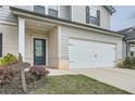 Close up view of the front of a charming home with a two car garage and concrete driveway at 4929 Dufour Dr, Lilburn, GA 30047