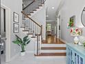 Welcoming home entryway with wooden stairs, a stylish console table, and charming decor at 7 Nesbit Pl, Alpharetta, GA 30022