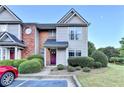 Inviting two-story townhome with neat landscaping and a freshly painted front door at 801 Old Peachtree Nw Rd # 56, Lawrenceville, GA 30043