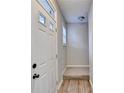 Bright foyer with hardwood floors, a window, and a stairway leading to the next level at 801 Old Peachtree Nw Rd # 56, Lawrenceville, GA 30043