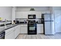 Modern kitchen featuring sleek countertops, stainless steel appliances, and ample cabinet space at 801 Old Peachtree Nw Rd # 56, Lawrenceville, GA 30043
