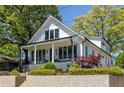 Stunning two-story home featuring a classic design, inviting porch and lush landscaping at 1076 Manigault Se St, Atlanta, GA 30316