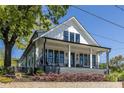 Inviting two-story home with a covered front porch and beautifully landscaped front yard at 1076 Manigault Se St, Atlanta, GA 30316