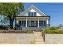 Charming two-story home with a welcoming front porch and manicured landscaping, perfect for curb appeal at 1076 Manigault Se St, Atlanta, GA 30316