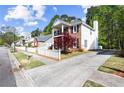 This home features a long driveway, and a small lawn, and is surrounded by mature trees at 4606 Liberty Square Dr, Acworth, GA 30101