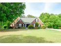 Charming single-story brick home with black shutters and a well-manicured lawn at 1412 Brighton Pl, Loganville, GA 30052