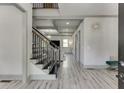 Bright foyer featuring wood-look floors, coffered ceilings, iron stair railings at 4208 Sierra Creek Ct, Hoschton, GA 30548