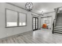 Spacious living room with hardwood flooring and a view into the formal dining area at 4208 Sierra Creek Ct, Hoschton, GA 30548