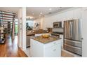 Bright kitchen features stainless steel appliances, white cabinets, granite countertops, and a stylish island at 1253 Caroline Ne St # 229, Atlanta, GA 30307