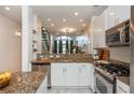 Open kitchen with granite countertops, stainless steel appliances, and contemporary white cabinets at 1253 Caroline Ne St # 229, Atlanta, GA 30307