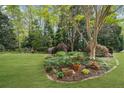 Spacious backyard featuring a well-manicured lawn and mature trees at 1410 Daley Ridge Ct, Lawrenceville, GA 30045