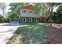 View of a two-story home with colorful exterior and a green lawn at 2538 Three Bars Drive, Grayson, GA 30017