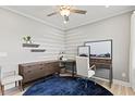 Bright home office with floating shelves, modern decor, and a comfortable workspace at 328 Foxglove Way, Mcdonough, GA 30253
