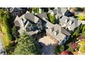 Stunning aerial view of a stately home with a three-car garage and well-manicured landscaping at 5473 Heyward Square Pl, Marietta, GA 30068