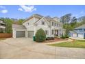 View of the house, showing attached garage and landscaping at 603 Redcoat Cir, Canton, GA 30114