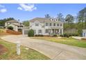View of the house, showing long driveway and landscaping at 603 Redcoat Cir, Canton, GA 30114