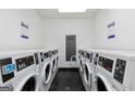 Functional laundry room features multiple washing machines, providing convenient and efficient laundry services at 795 Hammond Dr # 806, Sandy Springs, GA 30328