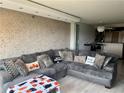 Spacious living room with a comfortable sectional sofa and a unique textured wall finish at 795 Hammond Dr # 806, Sandy Springs, GA 30328